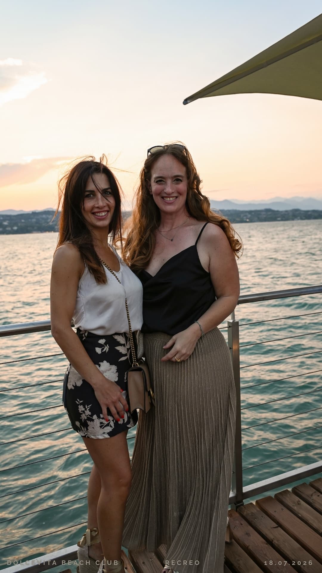 Due amiche posano al tramonto sul lago